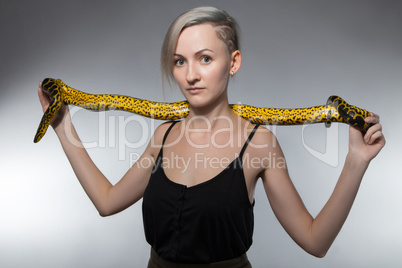 Woman stretching yellow snake