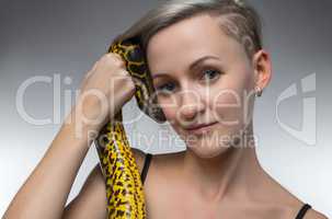 Smiling woman holding yellow snake