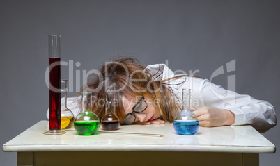 Sleeping scientist with glass flask
