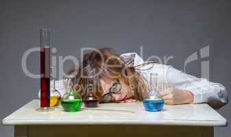 Sleeping scientist with glass flask