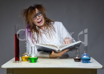 Reading laughing scientist with glass flask