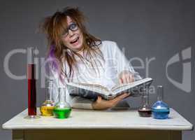 Reading laughing scientist with glass flask