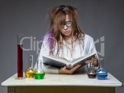 Reading serious scientist with glass flask