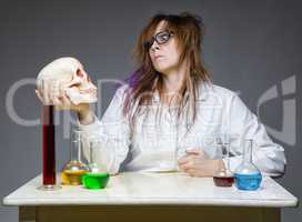 Serious scientist with human skull