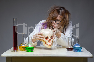 Exploring scientist with human skull