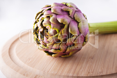 Fresh Artichoke on a wooden plate