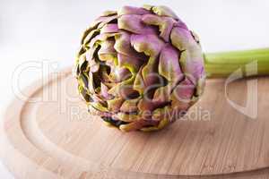 Fresh Artichoke on a wooden plate