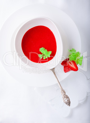 Strawberry soup with white napkin on a table.