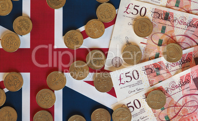 Pound coins and notes, United Kingdom over flag