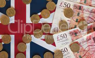 Pound coins and notes, United Kingdom over flag