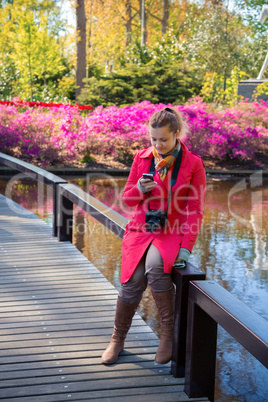 Young woman looks in a smartphone and smiles