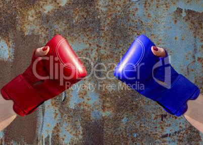 Two female hands in red and blue boxing gloves