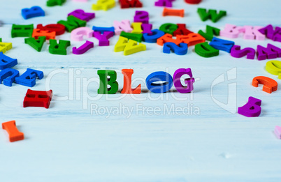 Word blog from small multicolored wooden letters on a white surf