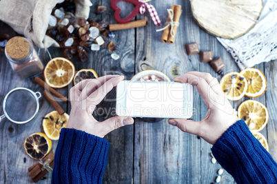 smartphone in female hands, process of photographing food