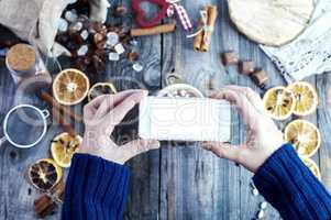 smartphone in female hands, process of photographing food