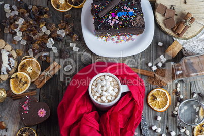 Hot chocolate with white marshmallow on a gray wooden surface