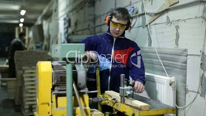 Carpenter drilling holes in dash with bench drill