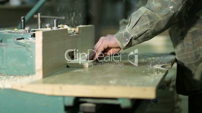 Carpepnter's hands working on electric cutter