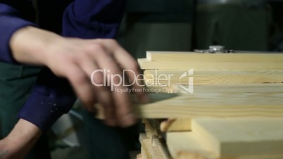 Carpenter working with electric planer machine