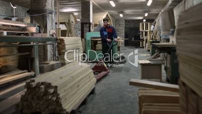 Carpenter working with manual forklift pallet