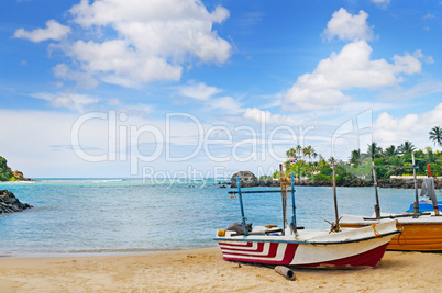 fishing boat on the sandy shore against a background the ocean a