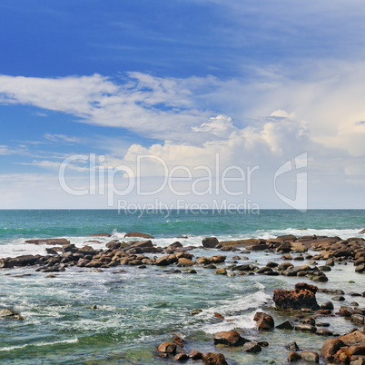 Scenic ocean, coral reef near the shore and blue sky.