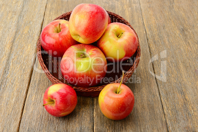 red apples on a wooden surface