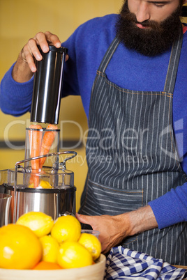 Male staff preparing juice at organic section