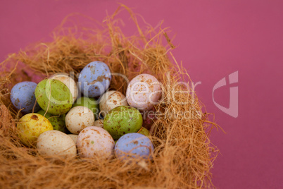 Colorful chocolate Easter eggs in the nest