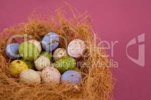 Colorful chocolate Easter eggs in the nest