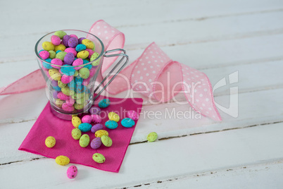 Mug filled with colorful chocolate Easter eggs