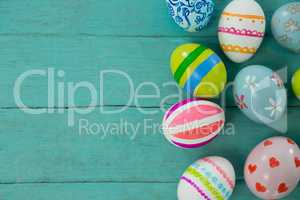 Painted Easter eggs on wooden plank