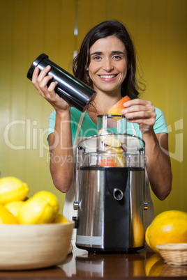 Portrait of smiling shop assistant preparing juice