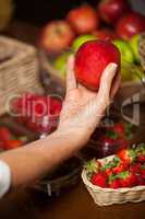 Hand of female staff holding a apple