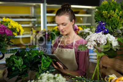 Female florist using digital tablet