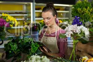 Female florist using digital tablet