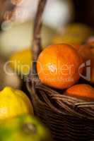 Close-up of fresh oranges in wicker basket at organic section