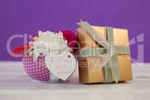 Gift box and bunch of fresh flowers with I love you mom card