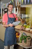 Male staff looking at clipboard in organic section