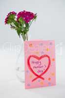 Close-up of happy mothers day card with flower vase