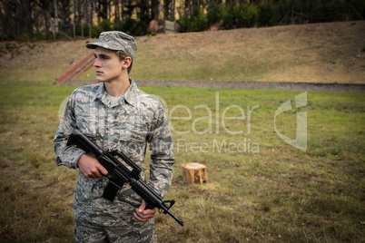 Military soldier guarding with a rifle