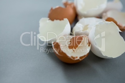 Broken brown egg on grey background