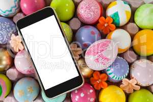 Mobile phone on painted easter eggs