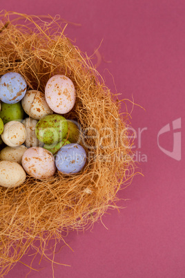 Colorful chocolate Easter eggs in the nest