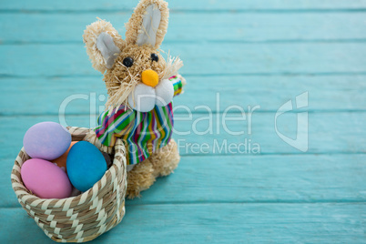 Basket with Easter eggs and toy Easter bunny