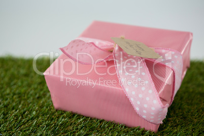 Gift box with happy mother day tag on grass