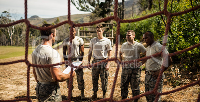 Male trainer instructing soldiers