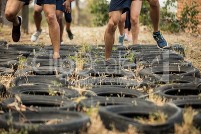 Low section of people receiving tire obstacle course training