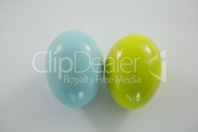Blue and yellow Easter eggs on white background