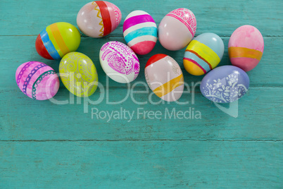 Painted Easter eggs on wooden plank